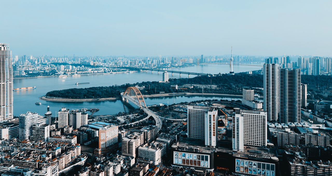 A breathtaking aerial view of a sprawling cityscape featuring bridges and skyscrapers along a vibrant river.
